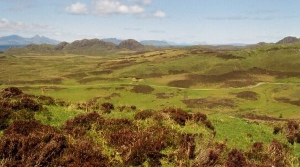 Ardnamurchan volcanic centre. This view looks across the heart of Ardnamurchan to the remnants of the ramparts of the volcano which created the peninsula. The Small Isles of Eigg and Rum, also volcanic in origin, can be seen beyond.