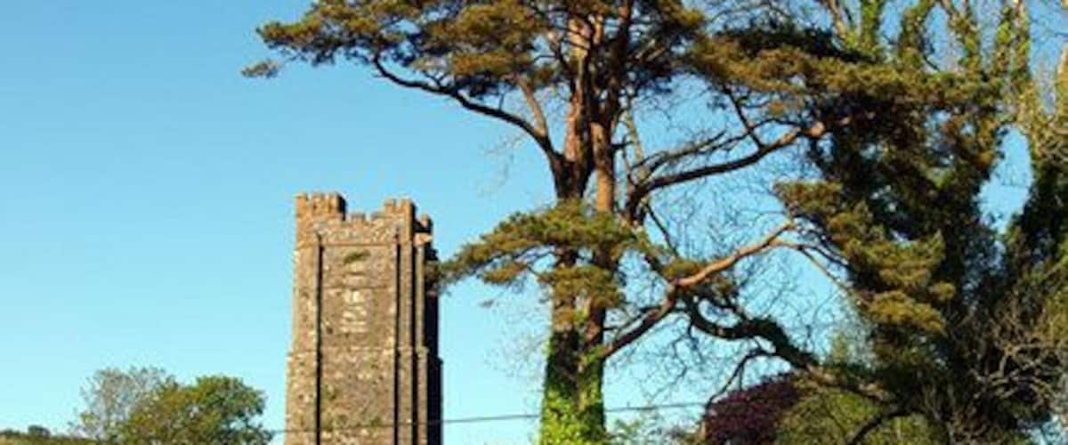 Road junction in Kentisbury, Devon, with the tower of St Thomas's parish church in the background