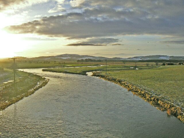 River Don. The River Don as it winds towards the camera and the village of Kemnay. Snow covered hills in the background.
