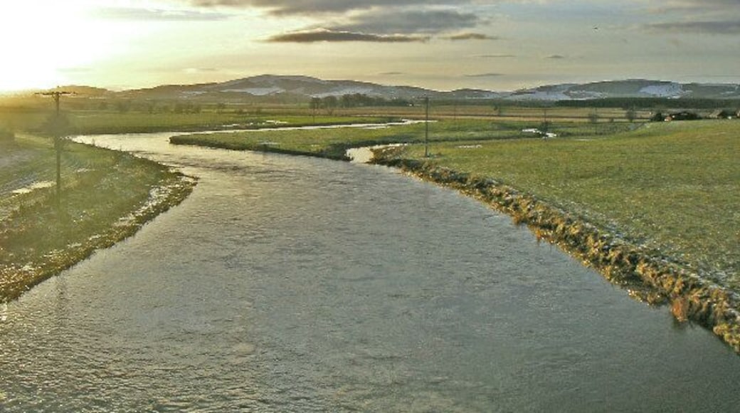 River Don. The River Don as it winds towards the camera and the village of Kemnay. Snow covered hills in the background.
