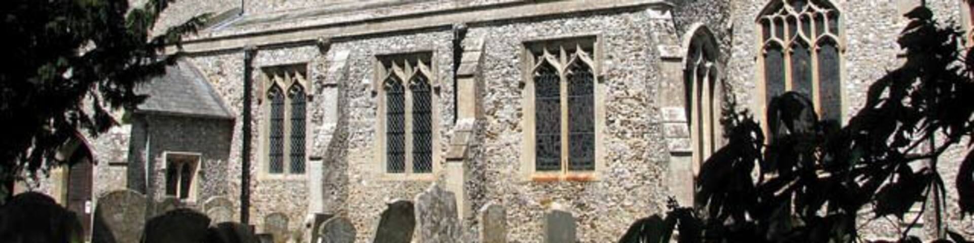 St Michael's church. St Michael's church is hemmed in by houses from all sides > 1300902 and difficult to reach. Although its tower can occasionally be glimpsed over roofs and through trees, there is only a narrow driveway > 1300904 and a short section of path leading to it. The churchyard contains a number of interesting old headstones and the remains of an ancient stone cross > 1300916 are situated right in front of the south porch > 1300909 which dates from the 15th century. The main body of the church > 1300908 was built a century earlier and the chancel wall contains lumps of carstone. The church interior > 1300927 - 1300941 was extensively restored by the architect G.E. Pritchett in the mid-19th century. It was during this time that the stained glass was put in many of the windows. According to the Norfolk churches website, St Michael's contains probably the best collection of late 19th and early 20th century glass of any small church in East Anglia > 1300958 - 1300968 - 1300974. Most of the stained glass windows were made in the workshop of the O'Connors and there is work by Robert Bayne and Christopher Webb. The originally square font has been cut at some state to form an octagon, ruining some of the carving > 1301005 - 1301020. The rood screen > 1300931 is also largely original albeit restored and covered with dark varnish. There is a three figure brass > 1301039 on the west tower wall which dates from 1623 and features Agnes Brigge and her parents. This church is kept locked but a key is available on request. http://www.norfolkchurches.co.uk/ingoldisthorpe/ingoldisthorpe.htm