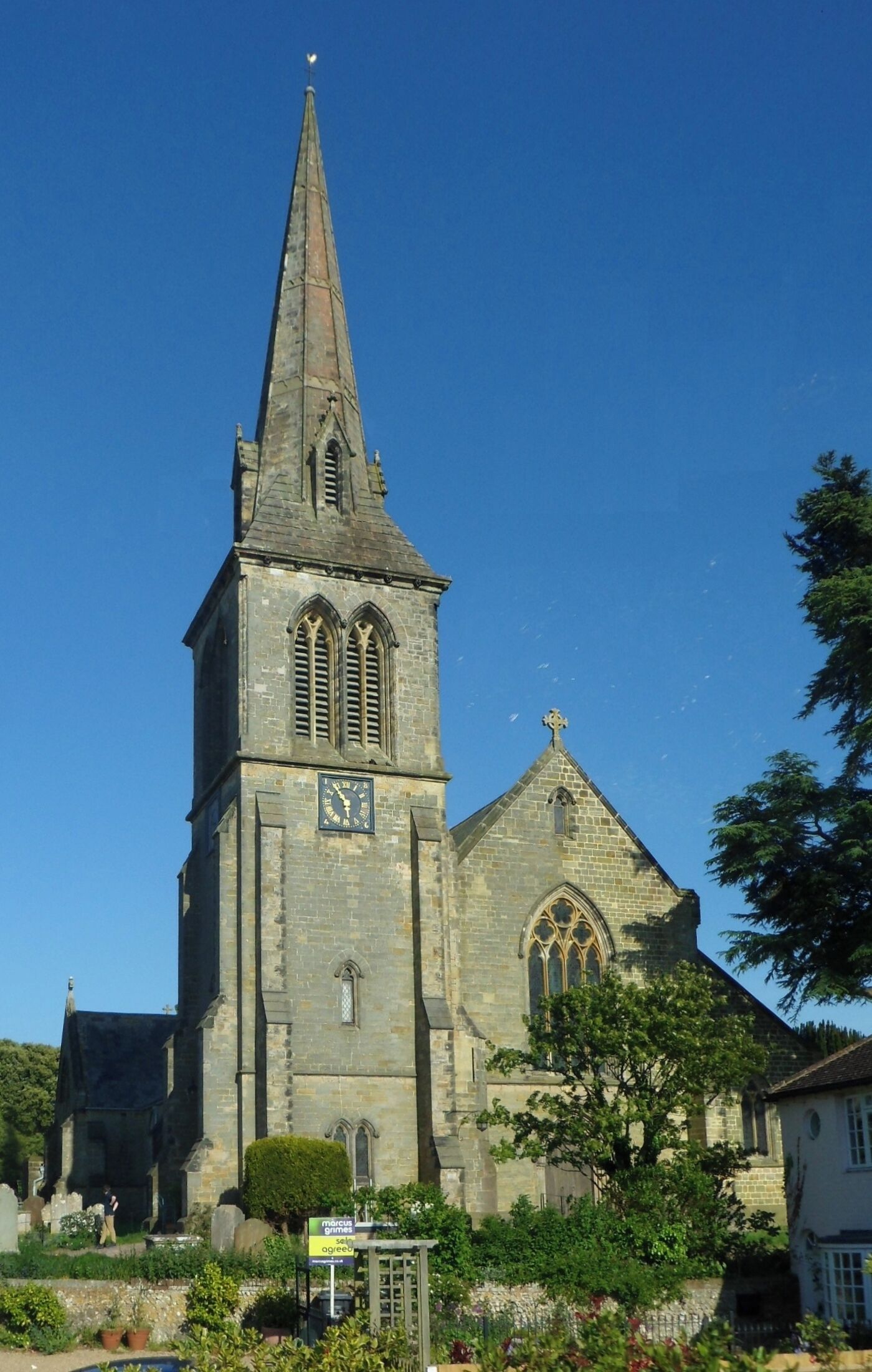 A church with a tall spire and a clock tower.