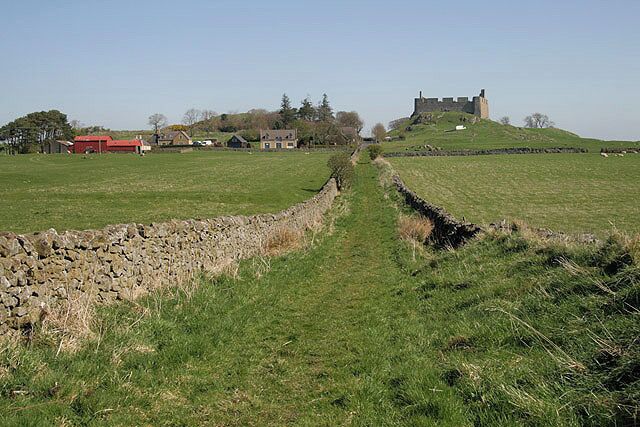 Walking towards Hume. This grassed track between drystane dykes provides pleasant walking, with the village of Hume ahead and Hume Castle prominent on the right. See 587757 for a view from the castle to this walled track.