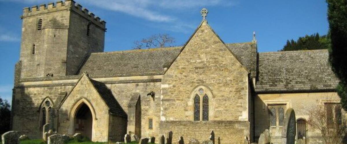 A historic church with a tower and a graveyard.