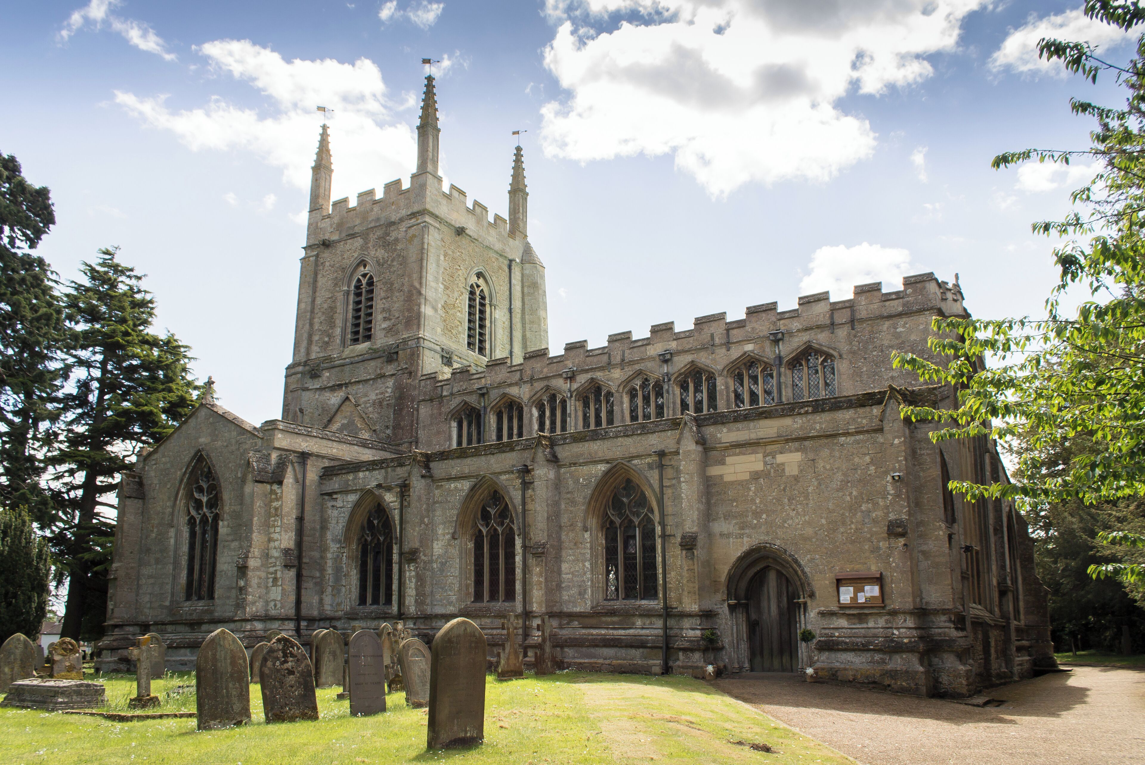 A historic church with a tall tower and arched windows.