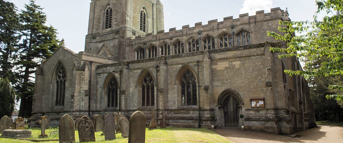 A historic church with a tall tower and arched windows.