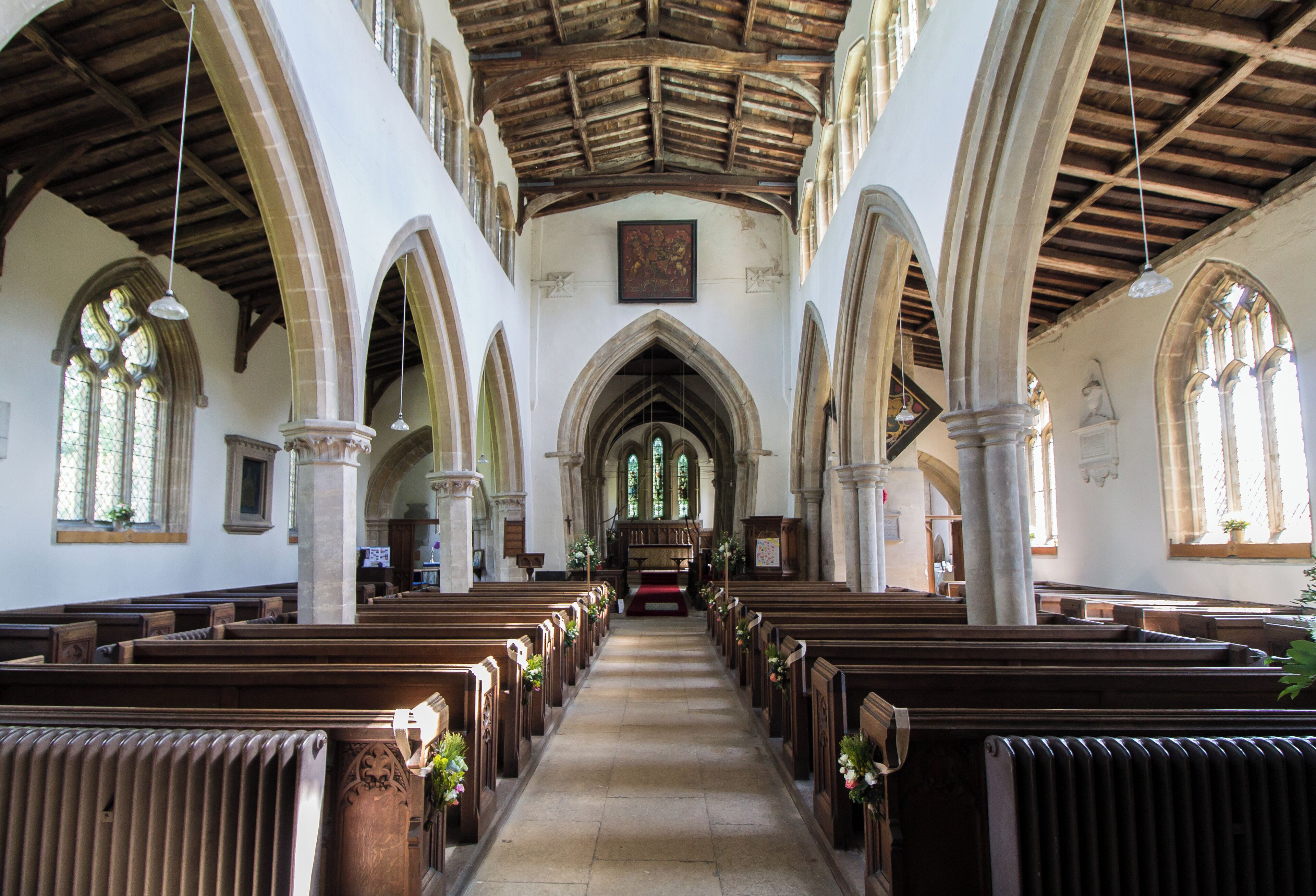 Grade I listed. The church dates from the late 12th century onwards, although a church was mentioned in the Domesday book. Originally there was a cruciform Norman church, parts of which still remain. The church could have been an ex Anglo-Saxon Minster or new Collegiate foundation. There is a nave with north and south aisles, north and south transepts with crossing tower, chancel and south porch. The west front dates from circa 1170 and was remodelled in the 15th century. The nave was constructed in the first half of the 13th century, the north and south arcades are asymmetrical. There is a set of eight windows in the late 15th century clerestory. There are four-bay arcades, the north on hexagonal piers the south has one round and two quatrefoil piers. The chancel dates from the 12th century, and unusually has a sedilia with a single round arch. The crossing tower was remodelled around 1330, and the tower has battlements and pinnacles and several gargoyles. The arches of the crossing are leaning out of line, and an attempt was made in the 14th century to repair them. This can easily been seen when looking at the nave towards the chancel. The north transept has a 15th century tomb recess with the arms of Sir Thomas La Launde, died 1470. This may also be part of an Easter Sepulchre. The church has several monuments with brass plate designed by Pugin. The octagonal font is from the 15th century and has instruments of the passion on each face. There is a two manual organ by Binns, which was removed from Bailgate Methodist Church, Lincoln. (Pic by Jenny)