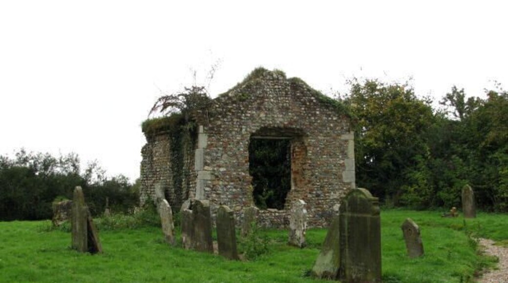 St George's ruin and cemetery - 19th century vestry. When the 1870 the tower crashed into the nave during the 1870s the church was abandoned. Only the ivy-covered tower and a 19th century vestry remain, the churchyard is still in use today. The new church, built in 1931-2 by Gilbert A. Perry, can be seen here > 321748 (exterior) and here 321752 (interior). For more information on the old church of St George's see http://www.norfolkchurches.co.uk/hindolvestonold/hindolvestonold.htm