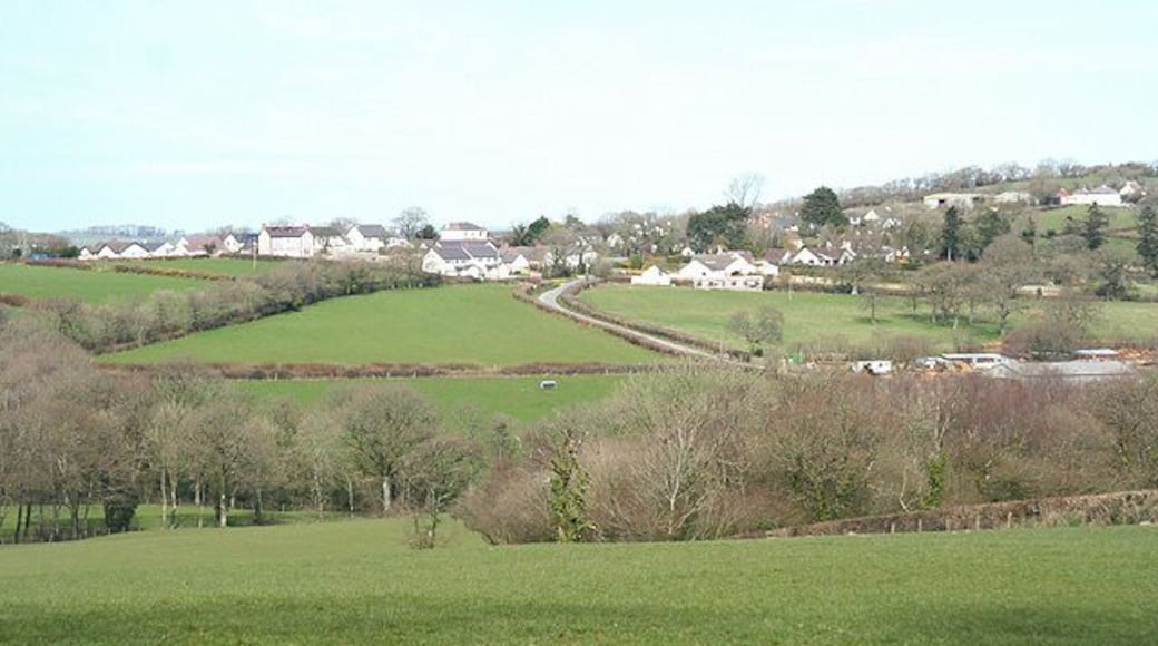 Highampton: towards the village The hedge running horizontally across the field below the village indicates the course of the Great Torrington - Halwill Junction Light Railway which has more recently become a cycle track linking Highampton with Black Torrington