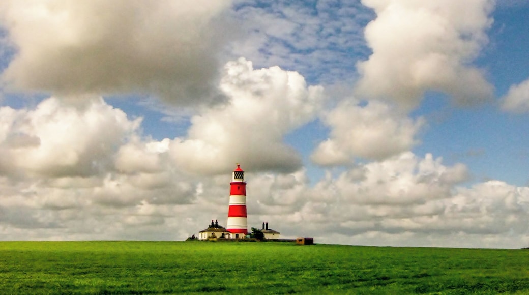 Happisburgh Lighthouse stands near the cliffs rapidly being eroded by the North Sea.
