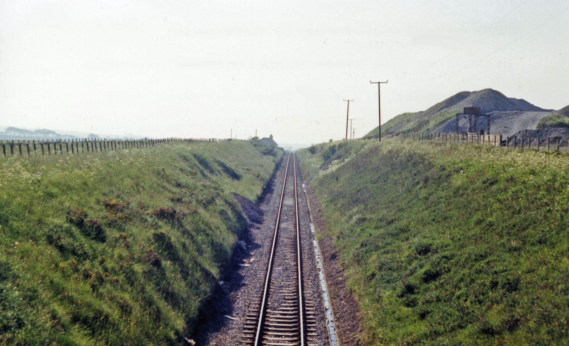 Approaching site of Bower station on line from Wick, 1986. View westward, towards Georgemas Junction and the south: ex-Highland Railway (Far North line), Inverness - Dingwall - Georgemas Junction - Thurso/Wick. The line remains active, but the former station - just visible ahead - was closed from 13/6/60 (goods 18/5/64).
