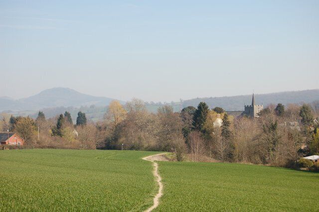 Guilsfield from the South west View of Guilsfield from the fields to the south west. The church can be seen right centre behind the trees