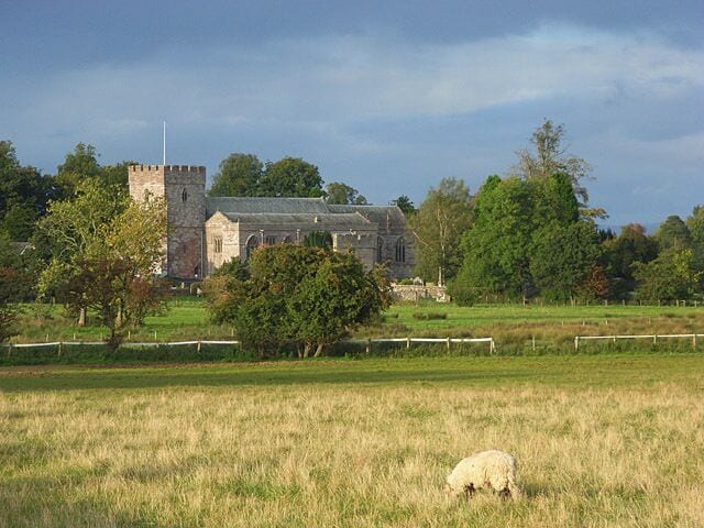St Andrew's, Greystoke, near to Greystoke, Cumbria, Great Britain. Looking across pastures from the southern end of the village. The church dates from the 13th century.