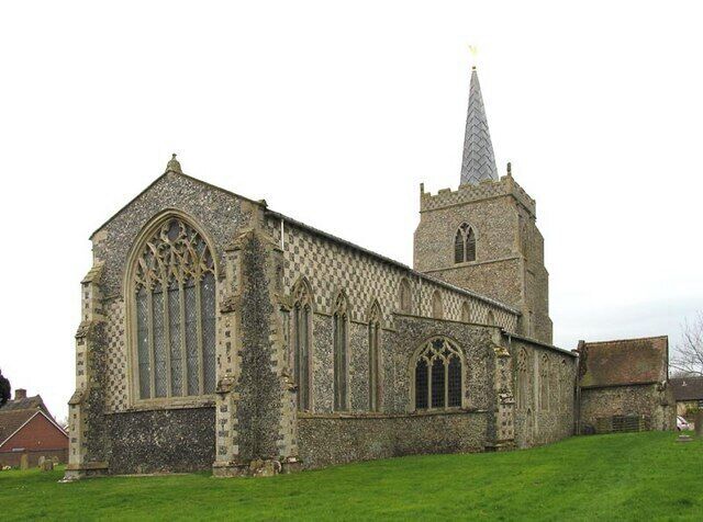 A historic church with large arched windows and a tall spire.