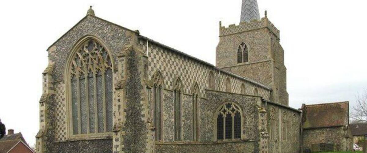 A historic church with large arched windows and a tall spire.