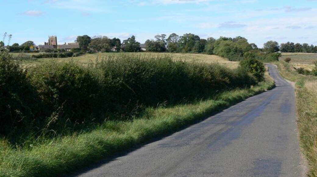Middleton Road towards Bringhurst The tower belongs to the Church of St Nicholas.