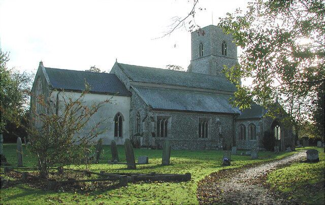 A church with a tower, surrounded by a cemetery with headstones.