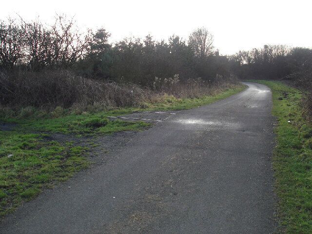 A Railway once ran here, south of Goxhill, Lincolnshire, England. Traces of the dismantled railway on an old level crossing near Goxhill, South End. Surprisingly, as can be seen in the photo, a short section of the rails still remains in place.