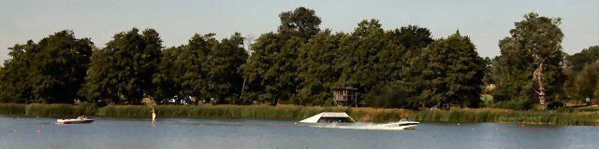 Gosfield Lake This large lake is used for recreational purposes. The speedboat in this photo has just passed the water-ski jump. See http://www.gosfieldlake.co.uk/
