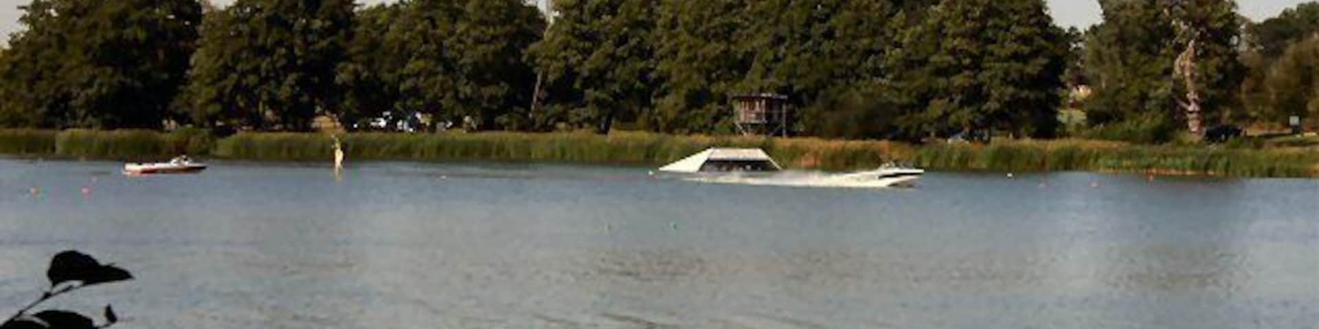 Gosfield Lake This large lake is used for recreational purposes. The speedboat in this photo has just passed the water-ski jump. See http://www.gosfieldlake.co.uk/