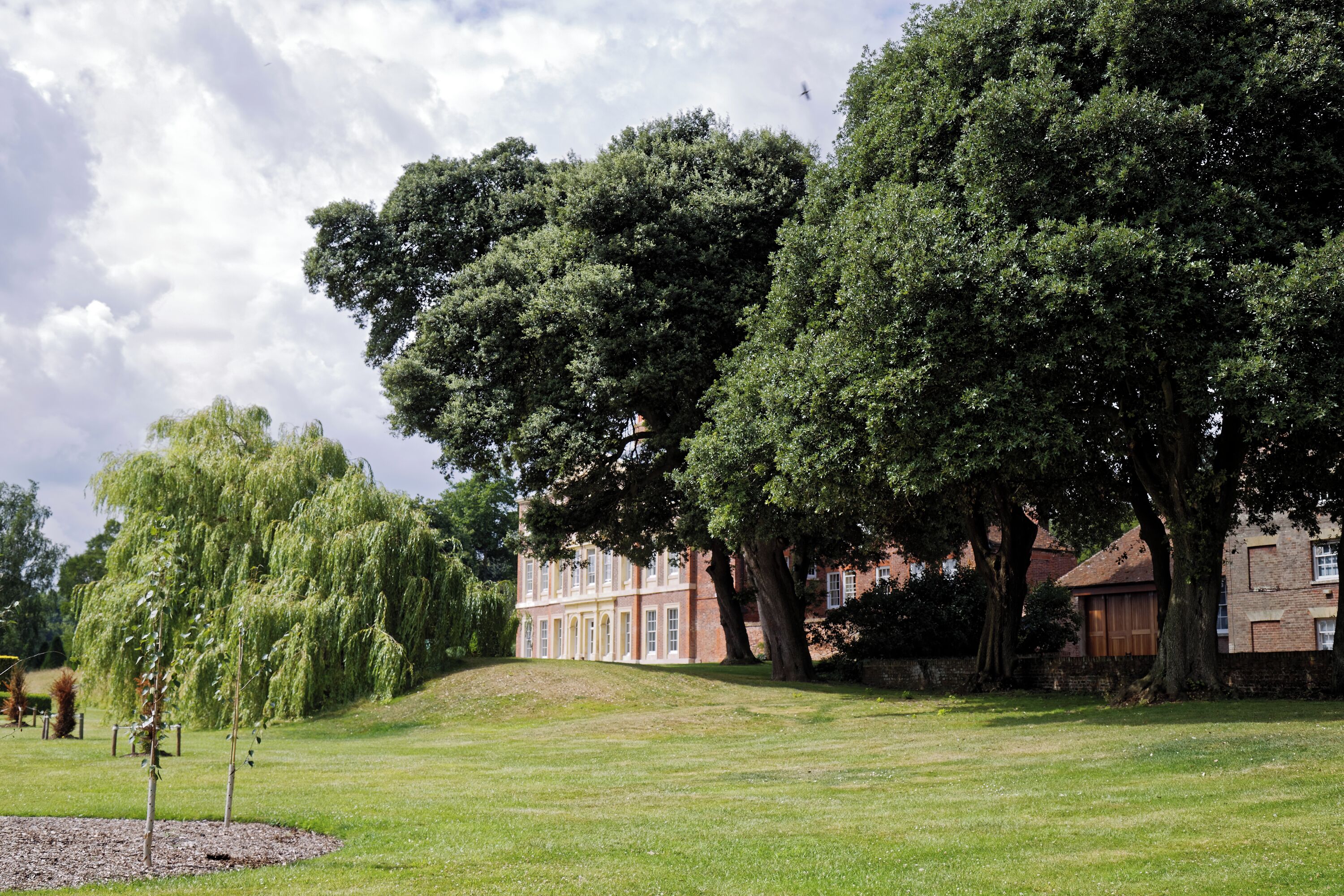 The south-east facing front lawn, including a weeping willow, of Goodnestone Park house at Goodnestone, in the Dover District of Kent, England. Camera: Canon EOS 6D with Canon EF 24-105mm F4L IS USM lens. Software: RAW file lens-corrected, optimized, perhaps cropped, and converted to JPEG with DxO OpticsPro 11 Elite, and likely further optimized with Adobe Photoshop CS2.