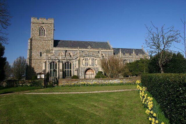 A historic stone church with a prominent tower and arched windows.