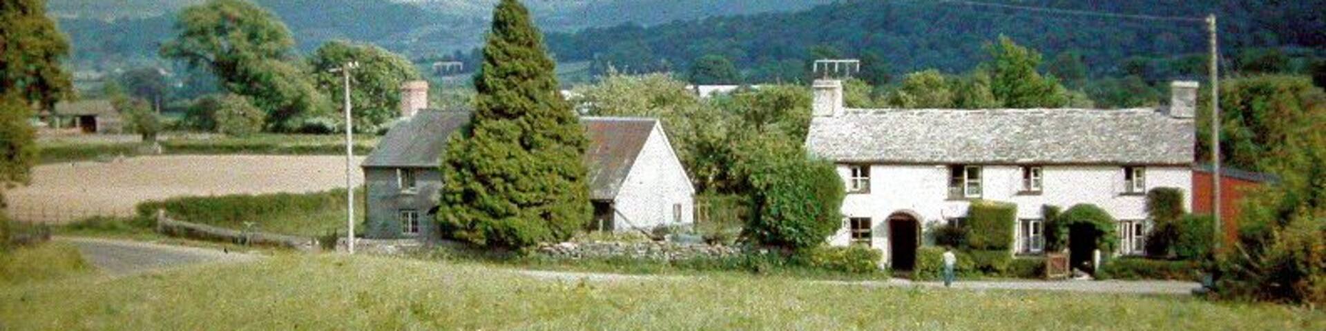 Across Wye Valley to Black Mountains from Boughrood Brest, 1962. View SE from B4350 near Boughrood Brest across Wye valley above Glasbury-on-Wye to the impressive north range of the Black Mountains (left-to-right: Hay Bluff (2,219 ft.), Lord Hereford's Knob (2,253 ft.), Waun Fach (2,660 ft.).