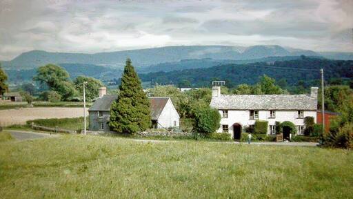 Across Wye Valley to Black Mountains from Boughrood Brest, 1962. View SE from B4350 near Boughrood Brest across Wye valley above Glasbury-on-Wye to the impressive north range of the Black Mountains (left-to-right: Hay Bluff (2,219 ft.), Lord Hereford's Knob (2,253 ft.), Waun Fach (2,660 ft.).
