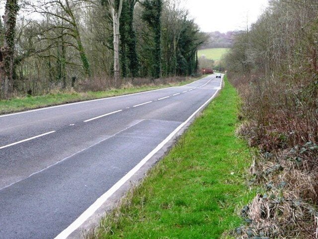 A438 near Clyro. The road clips the south-east corner of the square for a couple of hundred yards. It is one of the fastest parts of the A438. As I took this picture it was dark enough for the flash to go off. The driver of the approaching car slowed down and gave me a good look.