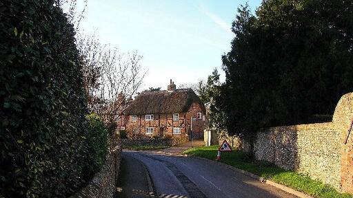 The Thatched House, West Ashling. What the picture doesn't make clear is the distinct herringbone brickwork. This view looks west from the junction of the B2146 and Down Street.