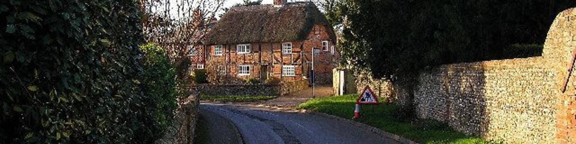 The Thatched House, West Ashling. What the picture doesn't make clear is the distinct herringbone brickwork. This view looks west from the junction of the B2146 and Down Street.