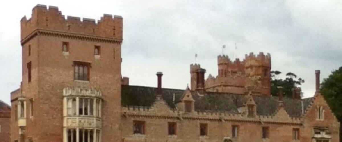 A large, historic castle with a prominent tower and multiple windows.