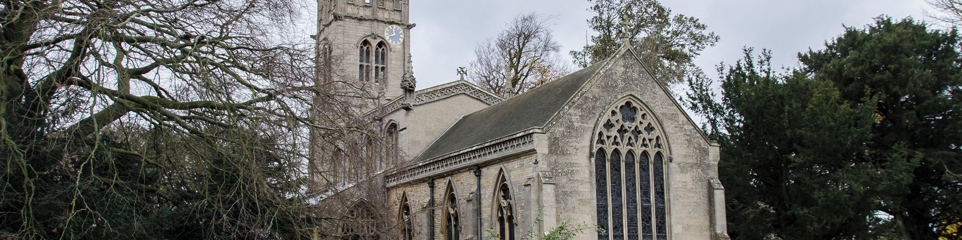 The church of St Nicholas is mainly of three periods, which may be dated around the years 1220, 1320 and 1470. There are some remnants in the church of an earlier building, for instance, the remains of the round Norman window, which can be seen in the south wall of the nave, the piece of carved stone built into the wall in the sanctuary. These two latter pieces of Norman work were dug up inside the church when the chancel arch was being restored in 1888. The only other piece of Norman work in the church is the font which is late Norman (around 1180). About the year 1220 the church was rebuilt, its length being the same as now, its width was somewhat less, the aisles being low and narrow. The roof was steep-pitched. Of this early 13th C. church there remains the pillars, the arcades, the lower part of the tower and the lower part of the chancel. The "trefoil" doorway into the chancel and the sedilia are Early English in date. About the year 1320 the side aisles were pulled down and the present aisles, porch and north and south doorways were built. The rounded C13 moulding giving way to a C14 pattern. The south aisle was apparently used as a side chapel with an altar at the east end. There still remains the brackets on which statues stood and the piscina, the floor of which has been delicately chiselled into the form of a cross. About the year 1470 the last great alteration to the church took place. The steep pitched roof gave way to a high flat roof and the church, which until now must have been dark, was lightened by the addition of clerestory windows. At the same time the tower was heightened and much of it rebuilt. The pinnacle at the south east corner of the clerestory carries the arms of the Myddletons of Fulbeck. The crest, a Saracens head surmounting a shield with a lion rampant, a belt with escallop shells supported on either side by a Harpy and a Wyvern. The Myddletons were the owners of Fulbeck from about the year 1430 to 1480. The church contains monuments to the Fanes of Fulbeck Hall.