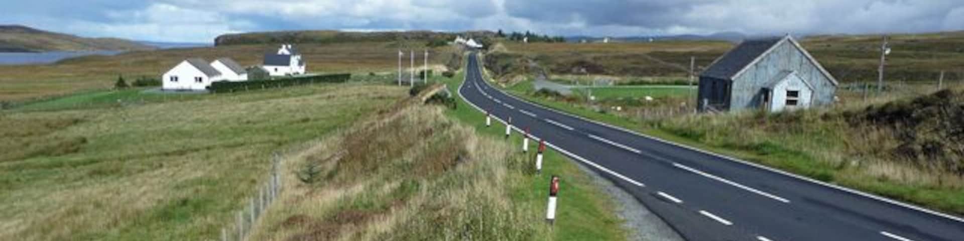 The A850 at Borve Heading towards Flashader. The corrugated iron building on the right is a church.