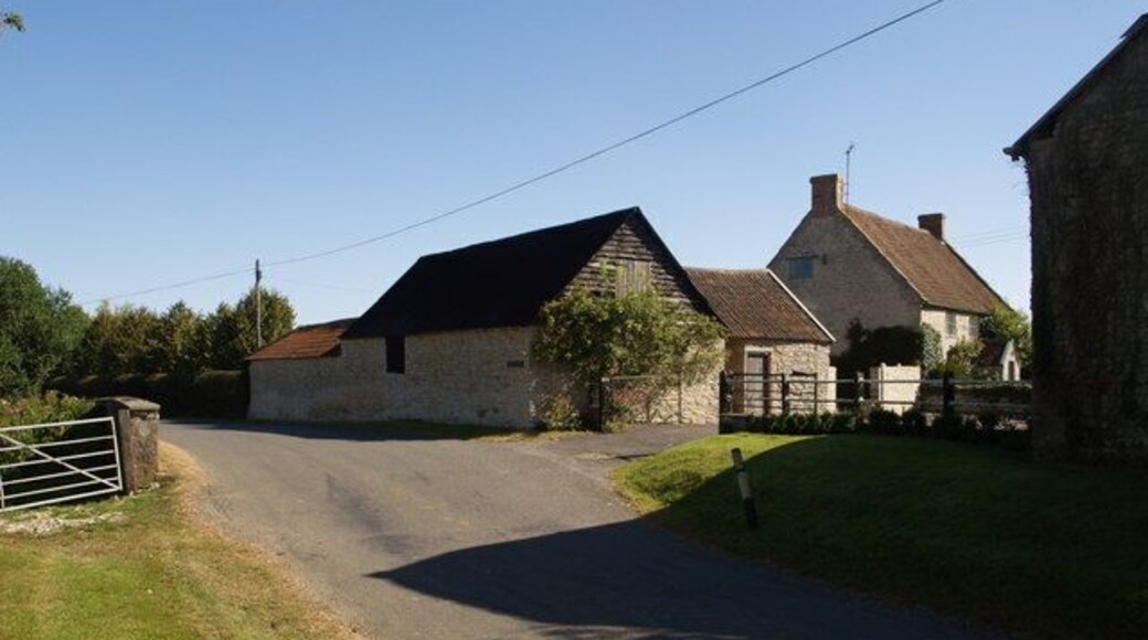 Two Bridges Farm The bulk of most of the buildings illustrated lies across the gridline in ST3421, but the walls and farmhouse facade facing the barn on the right are a metre or two inside ST3420. The Fivehead River is a mere metre or two away on the left, and in fact runs beneath the road wall opposite the end of left-hand building.