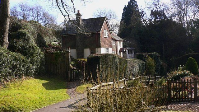 Cottage at Fernhurst The path in front of the houses is separated from the road by the gardens.