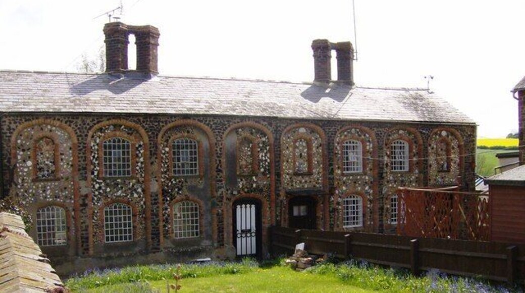 Passion Row, Farthingstone A fascinating row of cottages. Tudor in the style of the chimneys but probably Victorian. The stonework uses lots of different coloured stones, many untypical of the local ironstone. Together with an interesting design of mock archways the effect is very striking.