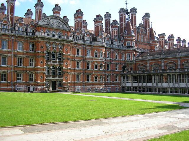 A large, historic building with a symmetrical facade, large windows, and a central entrance.