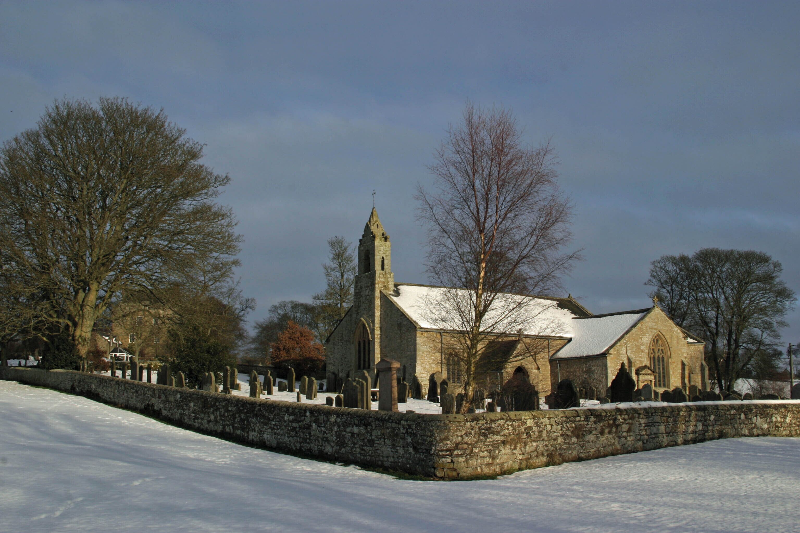 St Cuthbert's parish church, Elsdon, Northumberland, seen from the southwest in snow