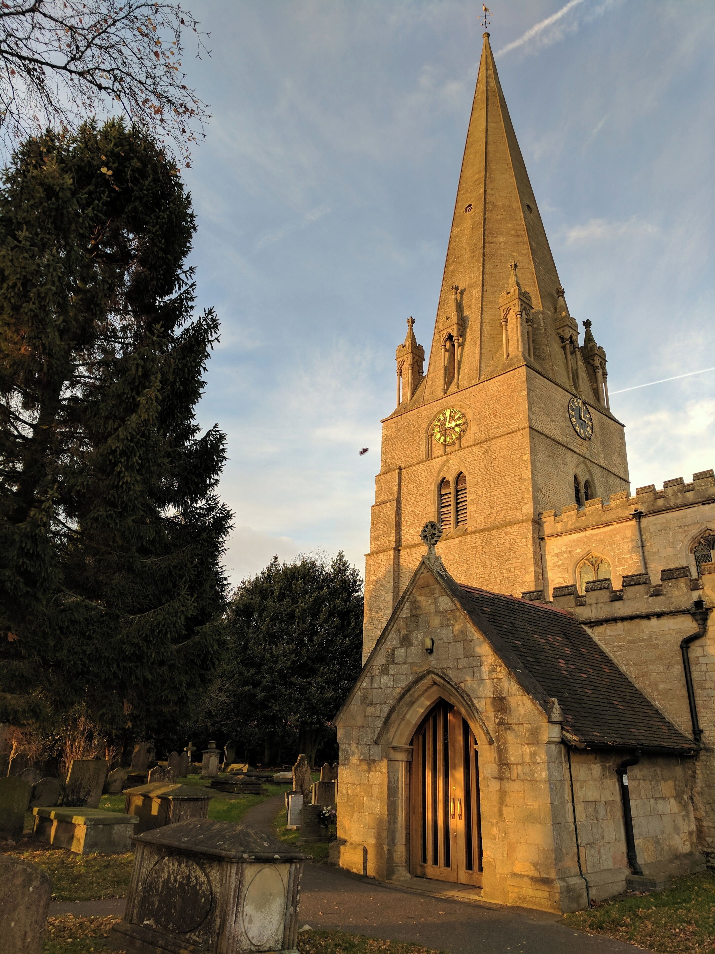 A church with a tall spire and a clock tower.