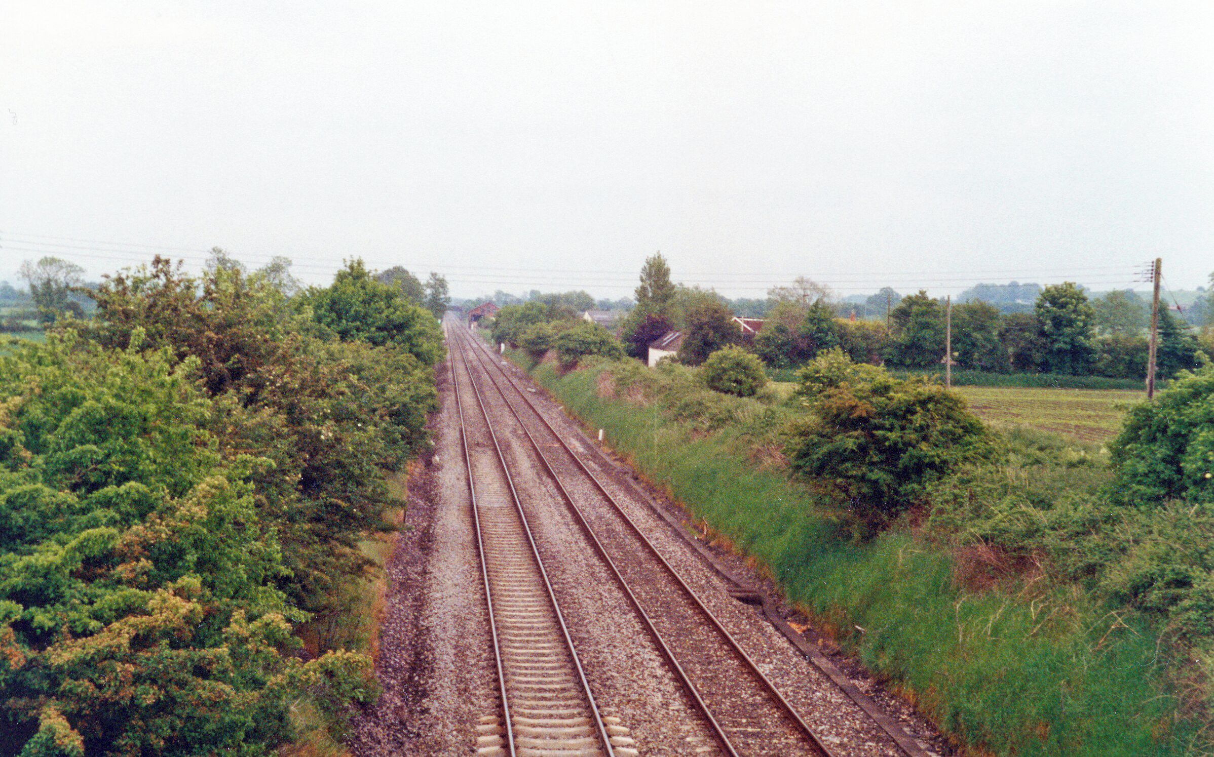 Site of former Edington & Bratton station, 1994. View west, towards Westbury and the West: ex-GWR London - Reading - Newbury - Westbury - Weymouth/Taunton and the West. The station been closed to passengers since 3/11/52, to goods 28/3/63.