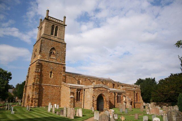 A historic church with a tall tower and arched windows.