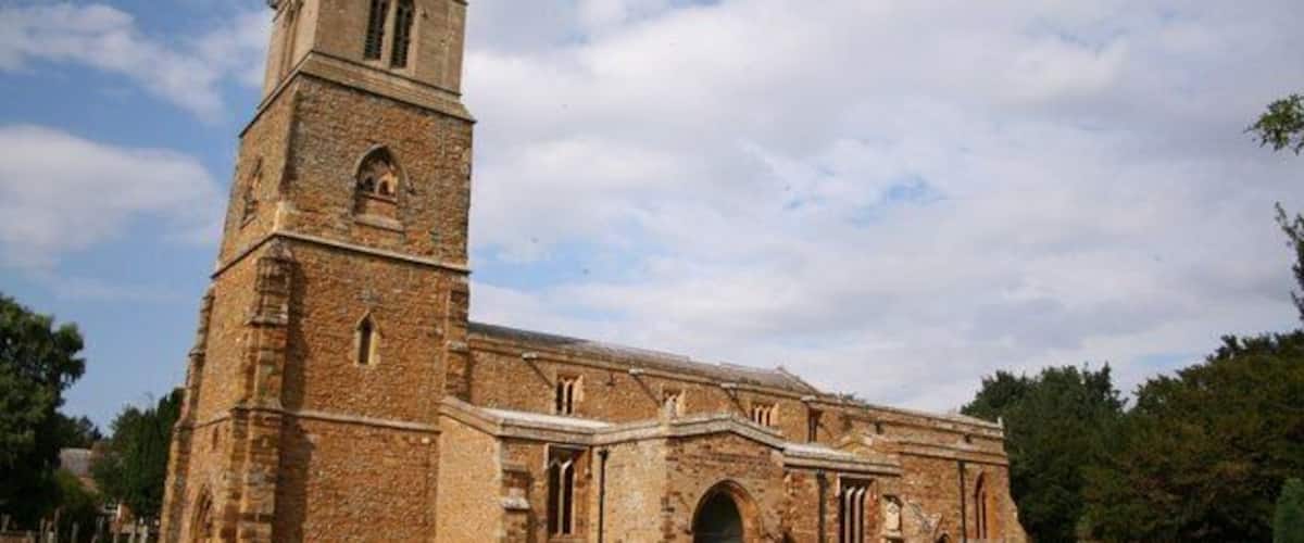 A historic church with a tall tower and arched windows.
