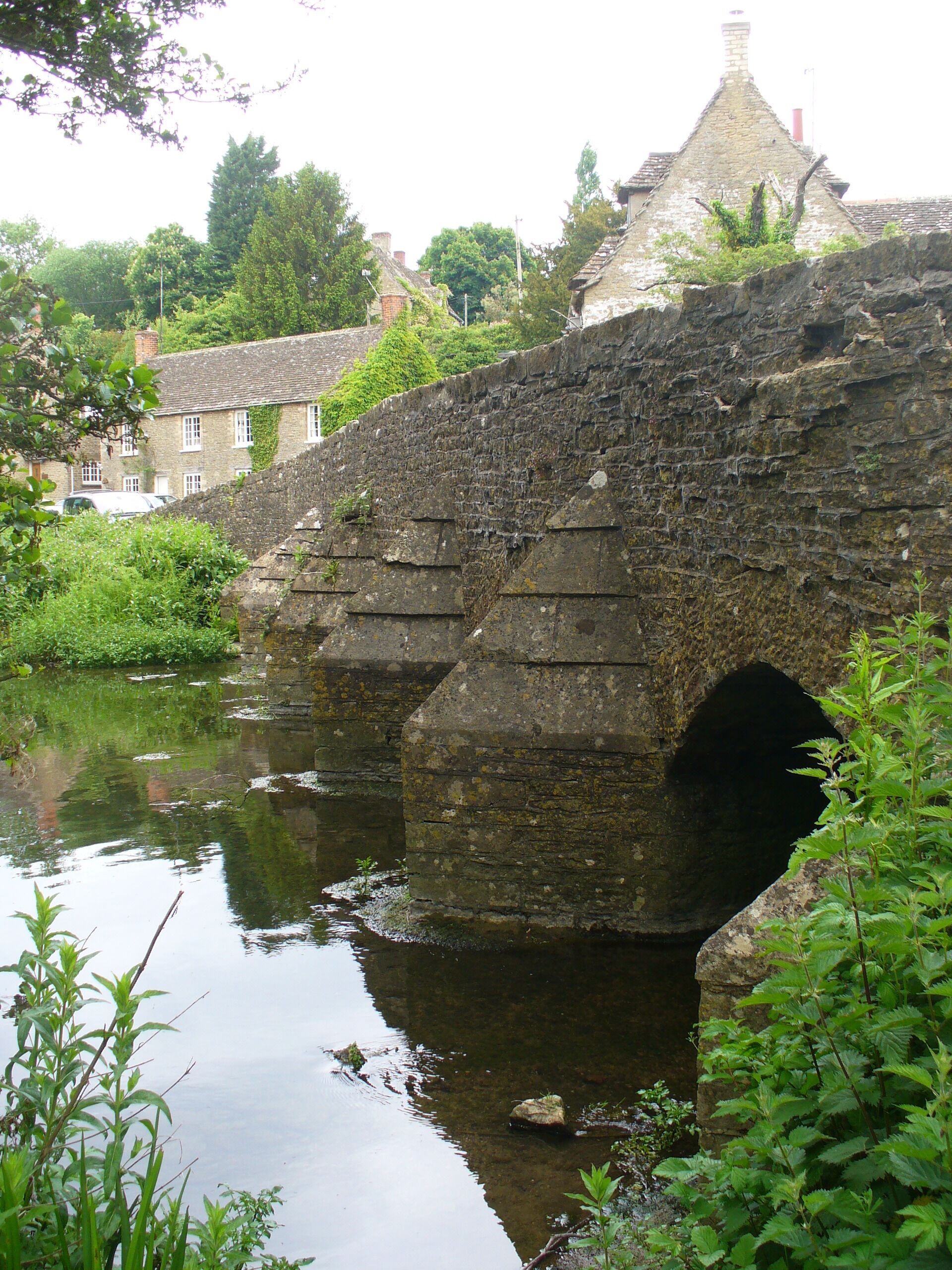 Easton Grey Bridge. Cotswold stone arched bridge, with cutwaters, spanning the Sherston arm of the Wiltshire Avon.