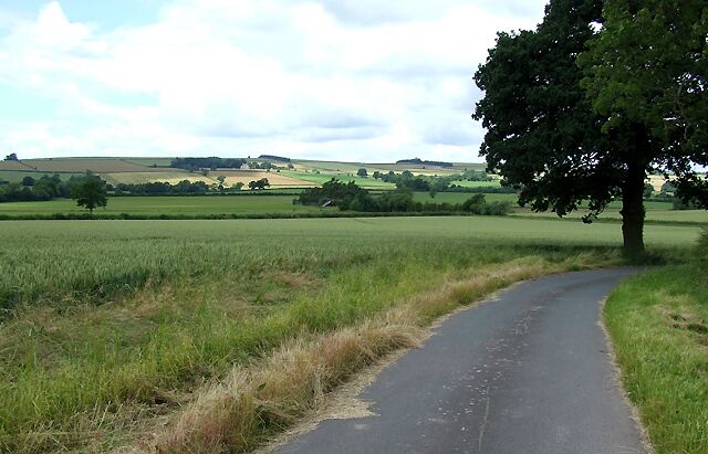 The Road to Corve Barn, Shropshire The public footpath across the wheat field is just visible at the far end.
