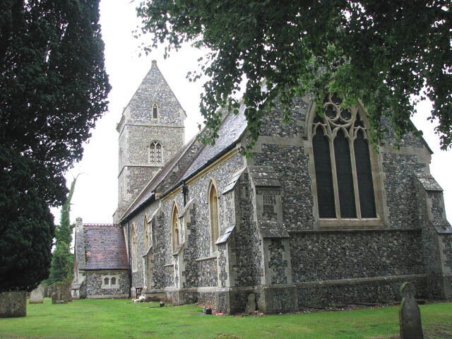 The church of St Ethelbert in East Wretham. The church of St Ethelbert > 1404082 with its distinctive saddleback tower was rebuilt in 1865 for the Birch family by the architect George Street and furnishings as well as stained glass > 1758761 date from this time. The only older survival is the Norman south doorway > 1404084. The font was made in 1883 of Corsham stone and the font cover > 1758750 was designed by architect JA Reeve, who based his design upon the medieval one in St Mary's church in Elsing > 890945. The frescoes on the east wall > 1758744 were painted 150 years ago by the then Rector, Revd JP Whalley, who also painted the font cover > 1758751 and the carved reredos > 1758748. What is believed to be an unusual royal arms - it is for Queen Elizabeth I (1558-1603) - in stained glass > 1758756 can be found set into a north wall window, hiding behind the organ > 1758754 which is a particularly good example of an early instrument built by James Corps in 1866, and is listed as Grade II in the British Institute of Organ Studies' register for historic pipe organs. The floral decoration on the organ case - executed by Revd JP Whalley - was discovered under a thick coat of blue paint which has since been painstakingly removed.