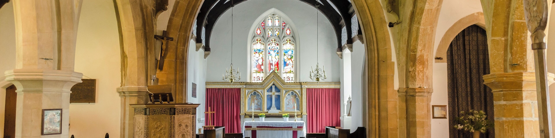 St Mary's at East Barkwith is one of 6 parish churches of the united Parish of the Barkwith Group. The church has undergone several rebuildings, so the present structure is a combination of different styles. There is no record of when the first church was built here, or of its appearance. The Domesday Survey of 1086 records a church at Barkwith, but it is not known of it was on this site or at West Barkwith. The earliest parts of the church date from between 12th and 13th C onwards, and subsequent dating may be determined by the style of the architecture, Perpendicular, which may be seen in the entrance door and porch, the archway to the tower and the tower itself. The west window may have been reused from an earlier building and the bell openings in the upper tower were probably made in the 17th century. The south arcade also dates from the Perpendicular period. This part of the church saw Catholic services in the centuries before Henry VIII, then changed between Catholicism and Protestantism under Edward, Mary and Elizabeth, the introduction of the Book of Common Prayer (1549, 1552 and 1662), and the destruction of the religious statues and stained glass under the Puritans. In the 18th century there was a long period of neglect and decay in the Church of England. Nonconformist churches began to develop and split from the Anglican church, which suddently took fright and began to appoint incumbents and repair churches. At St Mary's, the chancel was rebuilt in 1846, the architect being J.B. Atkinson. In 1868/9 the nave was re-roofed; the north aisle, the arcade and the windows were rebuilt under the direction of R.J. Withers. The difference in colour and tooling between the original pillars and the 19th century pillars are quite obvious. The font dates probably from the 15th C. It is octagonal and is decorated with shields bearing nails, whip, crown of thorns and other instruments of Christ's Passion. The font is lead lined, and drains through the stem to the ground beneath, so that the hallowed water could not be taken for superstitious purposes. As the water was sometimes left in the bowl the lid could be fastened down; the marks where the hasp and padlock would have been can still be seen on the font. The pulpit is unusual, being made of metal, and was designed by Christopher Turnor of Panton Hall in the late 19thC.