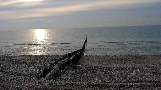 Bracklesham Bay. Looking south west onto a desolate beach on a cold winter's day.
