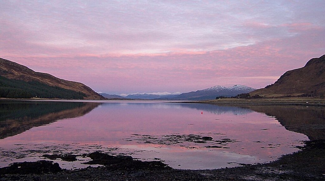 Evening over Caolas Scalpay Viewed from Strollamus. On the left is the tip of the island of Scalpay. On the right is the lower slopes of Creag Strollamus. The snow covered mountains in the distance are on the mainland.