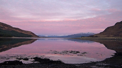 Evening over Caolas Scalpay Viewed from Strollamus. On the left is the tip of the island of Scalpay. On the right is the lower slopes of Creag Strollamus. The snow covered mountains in the distance are on the mainland.